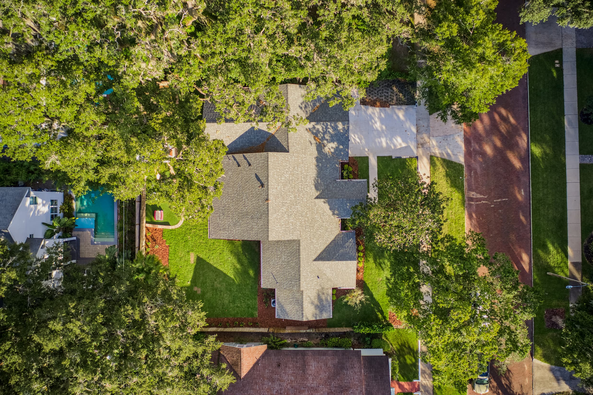 Aerial view of a completed shingle roof on a home in Central Florida